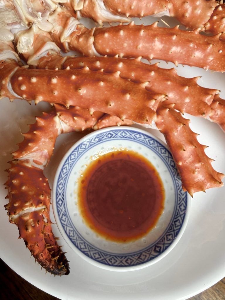 King crab legs served with A-Ma's Everything Sauce as a dipping sauce